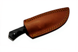 Damascus steel knife sheathed in a brown leather knife sheath on a white background