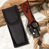 Knife with wooden handle and black sheath on a textured surface