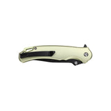 Folding knife with a beige handle and blade on a white background
