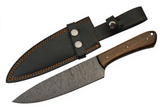 Handmade Damascus steel kitchen knife with walnut wood handle and black genuine leather sheath on a white background