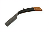 Curved Damascus steel blade razor with walnut and horn handle on a white background