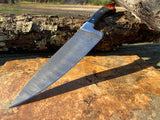 Large Damascus Kitchen Chef knife with a textured blade on a wooden surface