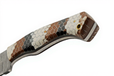 Close-up of a Damascus steel Texas Rattler handle with a honeycomb pattern on a white background