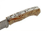 Handcrafted Damascus steel snowpeak hunter skinning knife's decorative filework extending through acrylic white and brown handle on a white background