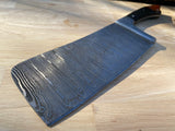 Damascus cleaver knife on a wooden surface