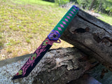  Kokushibo Demon Slayer folding knife open showing black tanto blade with pink floral artwork and green pink katana wrap handle scale
